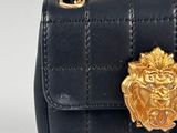 black quilted bag with gold lion head