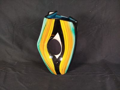 a vase that is sitting on a black surface