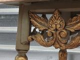 a wooden table with a carved design on top of it