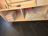 a shelf that has a pair of scissors on top of it