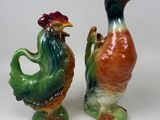 two figurines of birds that are standing next to each other