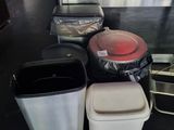 many trash cans sitting on the floor next to each other