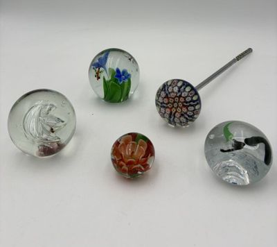 several different glass beads are arranged on a white surface