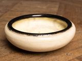 a bowl of soup sitting on a wooden table