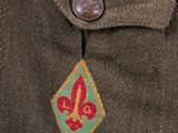 the back of a man ' s jacket with a badge on it