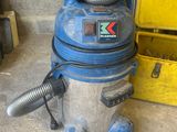 a blue and silver wet dryer sitting on the floor