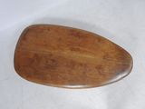 a wooden paddle that is on a white surface