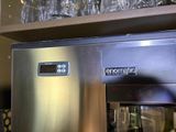 an image of a stainless steel refrigerator with wine glasses on top of it