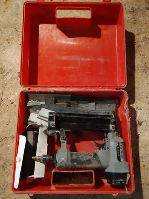 a red box with a stapler and a stapler in it