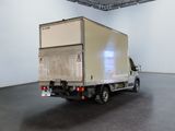 a white truck that is parked in a large room