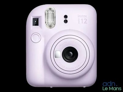 a white camera that is sitting on top of a table
