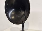 a black gramphone sitting on a table next to a white wall