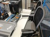 a desk with a laptop and a printer on it in a warehouse