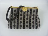 a close up of a purse on a white surface