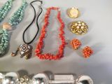 many different necklaces and bracelets that are on a table