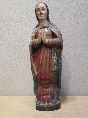 an old statue of a woman holding a baby in her arms