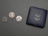 a small black box with coins and a small coin case