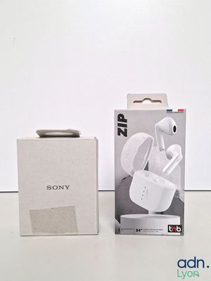 sony earphones in a box next to a box of packaging