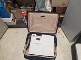 a suitcase with a laptop inside of it on the floor