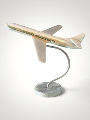 a model of a plane on a stand on a white surface