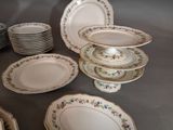 many plates and bowls arranged on a table