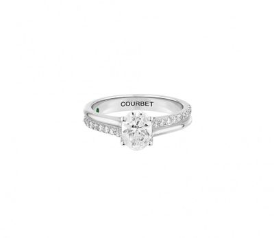 a close up of a ring with a diamond on it