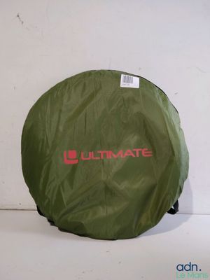 an image of a large green bag sitting on top of a white floor