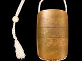 an image of a gold case with a tassel hanging from it ' s side