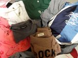 a pile of clothes that is sitting on the floor