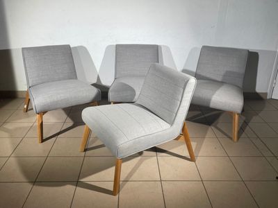 three chairs and a foot stool in a room with tile flooring