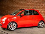 a small red car that is parked in a garage