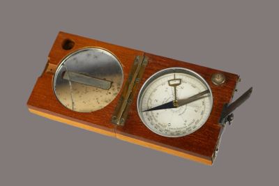 a wooden box with a clock and a compass on it