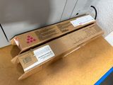 two boxes of pink ink sitting on top of a cardboard box