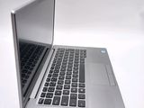 a silver laptop computer sitting on top of a white table