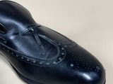 pair of men ' s black leather shoes with tassels on them