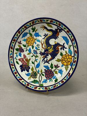 an image of a decorative plate with a bird and flowers on it