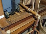a wooden chair that has a suitcase on top of it