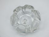 a clear glass ashtray with silver decorations on it