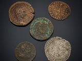 a group of five bronze coins