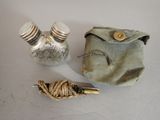 a small bag with two salt and pepper shakers next to it