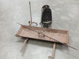 a small piece of metal sitting on the floor next to a small piece of wood