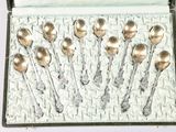 a box with a bunch of silver spoons in it