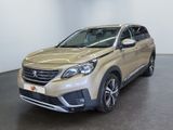 the front view of a beige suv parked in a room