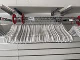 a rack of clothes hanging on the wall in a store