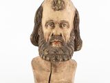 an old wooden bust of a man with a beard and long hair