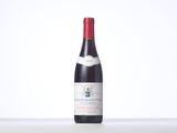 a bottle of red wine sitting on top of a table