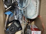 a cardboard box filled with electronic equipment and wires