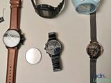 many different watches on a table with a watch on it