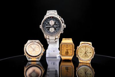 several different watches are displayed on a black surface with a black background