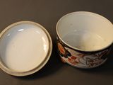a small bowl with a lid sitting on a table